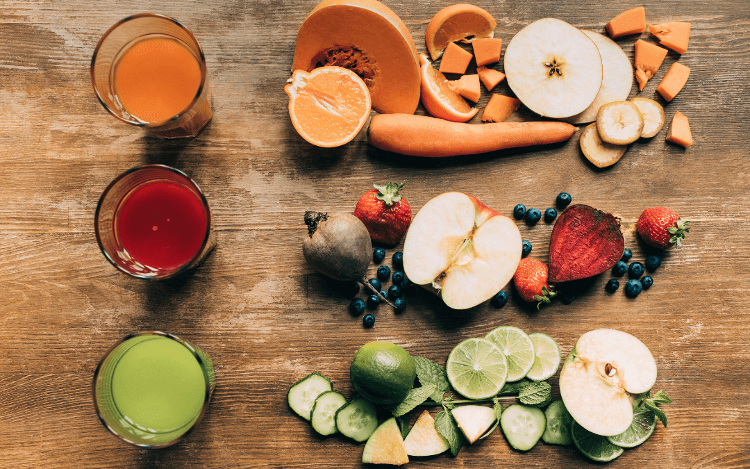 3 smoothies on the left. On the right: Piles of fruit and vegetables that went into the smoothie.