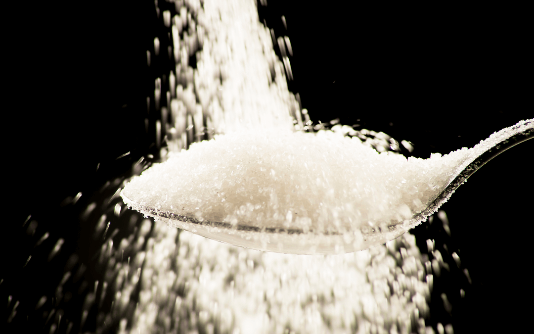 Spoon overflows with sugar.