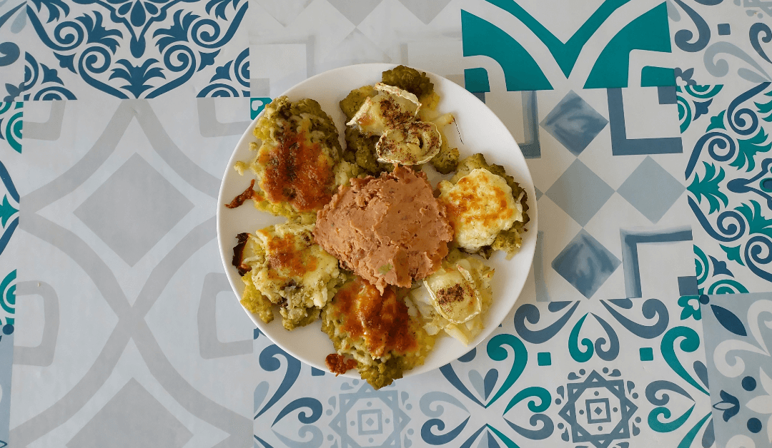 Broccoli covered with cheese and served with a bean dip.