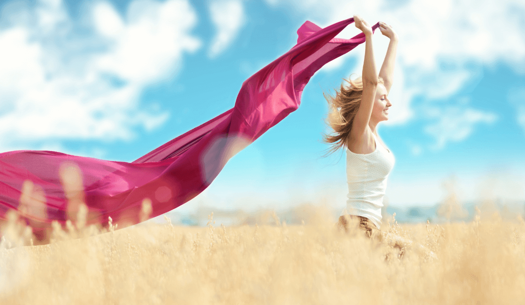 A woman skipping through a corn field, on the easy path.